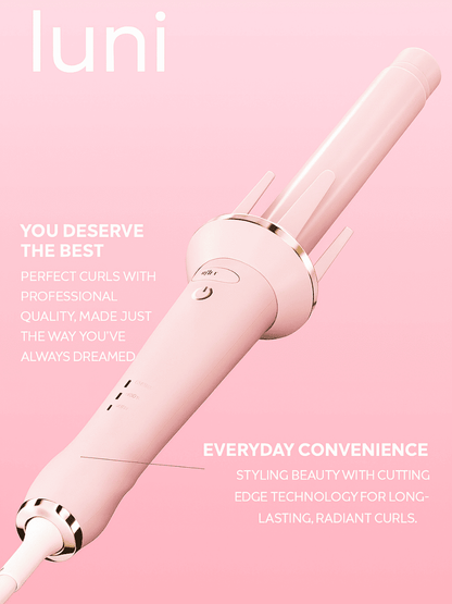 Pink hair curler with 'luni' branding on a pink background